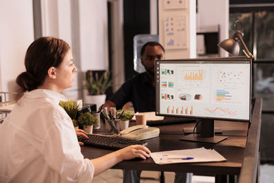 Side view of businesswoman working at office