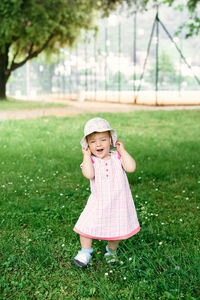 Portrait of cute girl wearing hat on field