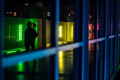 Man standing in illuminated room