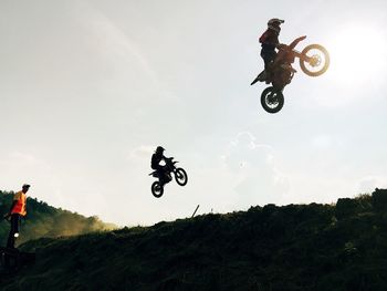 Man riding motorcycle against sky