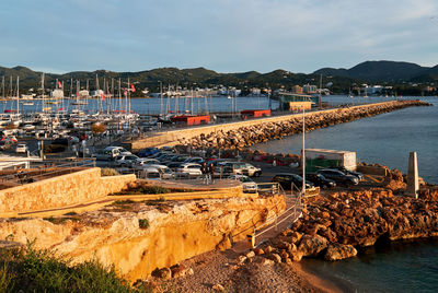 Sailboats moored in harbor