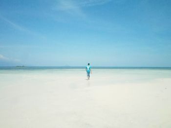 Scenic view of beach against blue sky