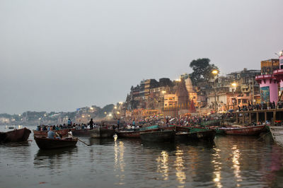 Varanasi, india  boats at river ganga ghat people among ancient hindu temples in early morning 