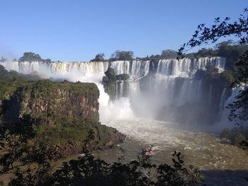 Scenic view of waterfall against clear sky
