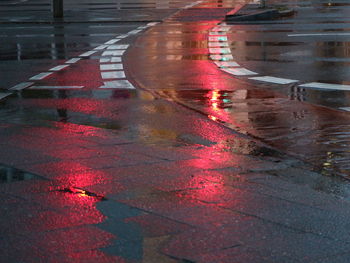 Close-up of red man with umbrella in city
