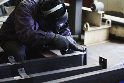 Man working on metal grate