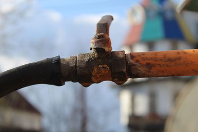 Close-up of rusty pipe against blurred background
