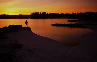 Scenic view of lake against sky during sunset