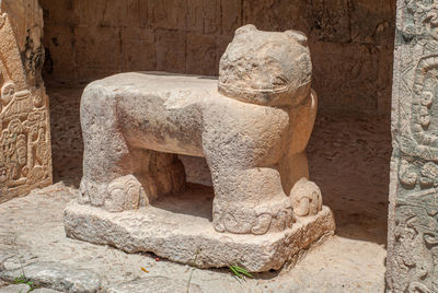 Close-up of statue against stone wall