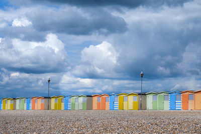 Multi colored houses on beach against sky