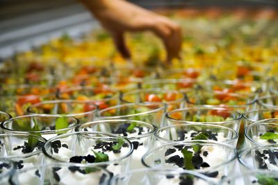 Cropped hand picking dessert at store