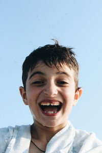 Portrait of smiling boy against sky