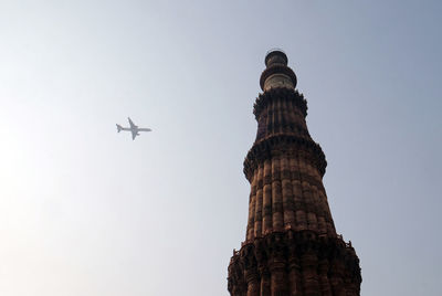 Low angle view of airplane flying against sky