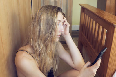 Beautiful young woman using mobile phone