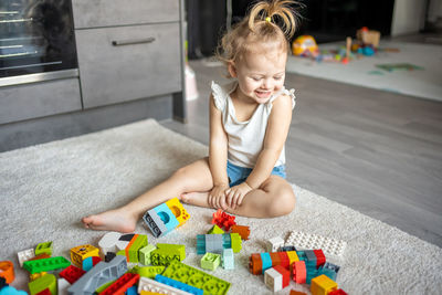 High angle view of cute girl playing with toys at home