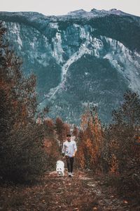 Man with dog walking on field