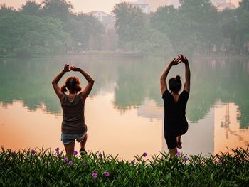 Rear view of couple standing in water