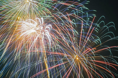 Low angle view of firework display at night