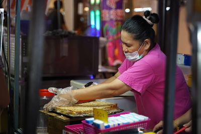 Side view of a woman in store