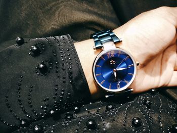 Close-up of hand holding clock