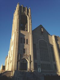 Low angle view of building against clear blue sky