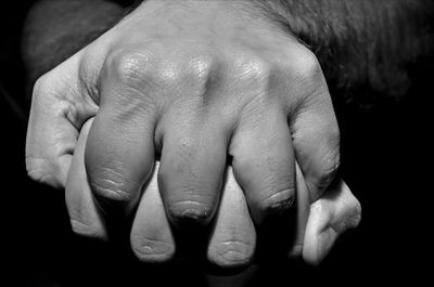 Close-up of hands over black background