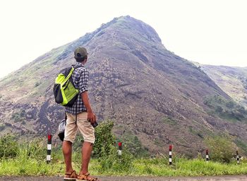 Rear view of man and woman against mountains against sky