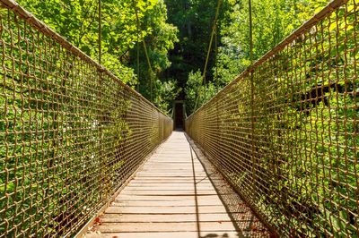 Rear view of woman walking on footbridge