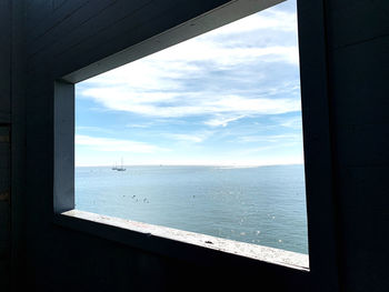 Scenic view of sea seen through window