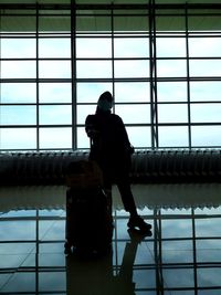 Rear view of man sitting at airport