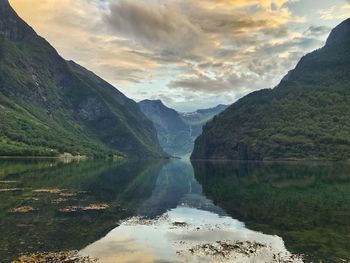 Scenic view of lake and mountains against sky