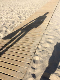 High angle view of footprints on sand at beach