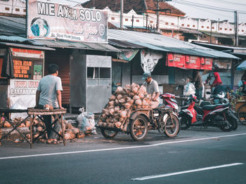 Bicycles parked on road against buildings