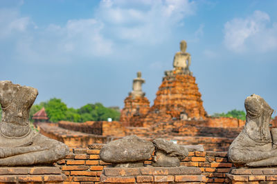 Statue of temple in building against sky