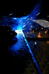 Close-up of hands working at night