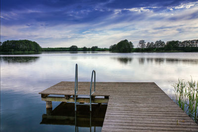 Wooden jetty against calm lake