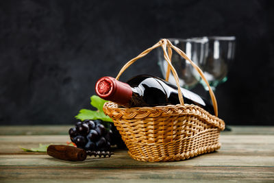 Close-up of wine bottle in basket on table