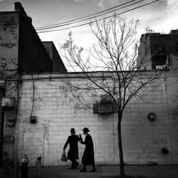 Hasidic jews in front of building in city