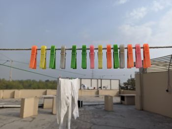 Clothes drying on beach against sky