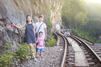 Full length of a woman standing on railroad track