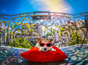 High angle view of sunglasses on swimming pool against sky