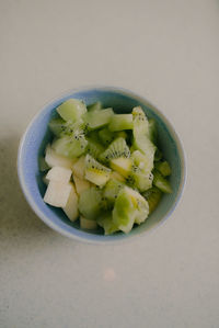 High angle view of chopped fruits in bowl on table