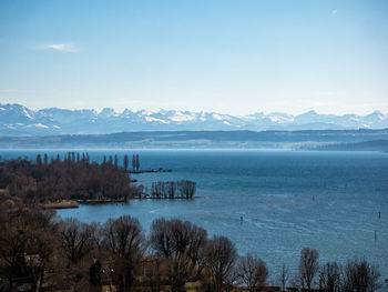 Scenic view of sea and mountains against sky