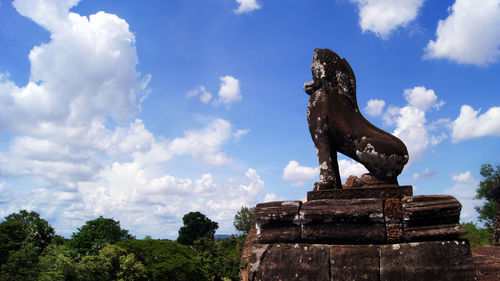 Low angle view of statue against sky