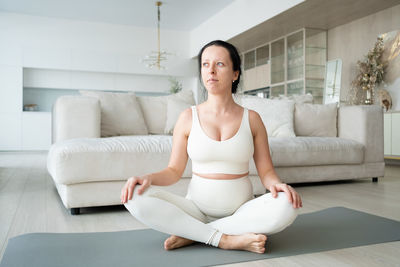 Pregnant woman meditating at home