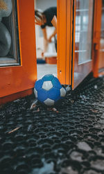 Close-up of soccer ball on window of building