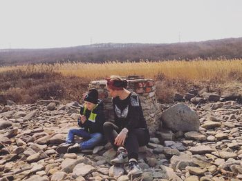 Men sitting on rock