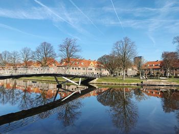 Arch bridge over river against sky