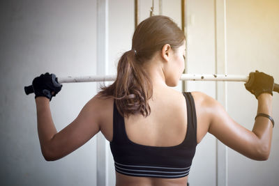 Young woman exercising in gym