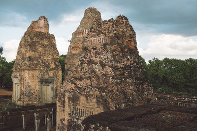 Ancient temple against cloudy sky